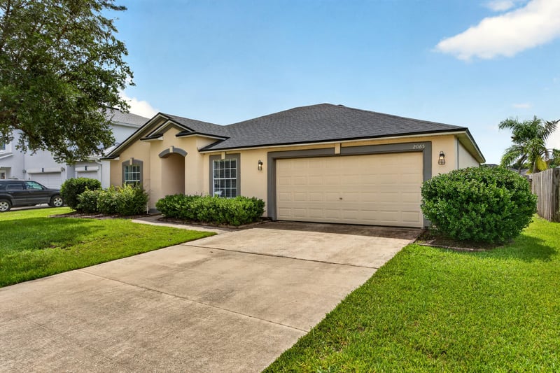 Front exterior with garage door and concrete driveway at 2065 Creekmont Dr