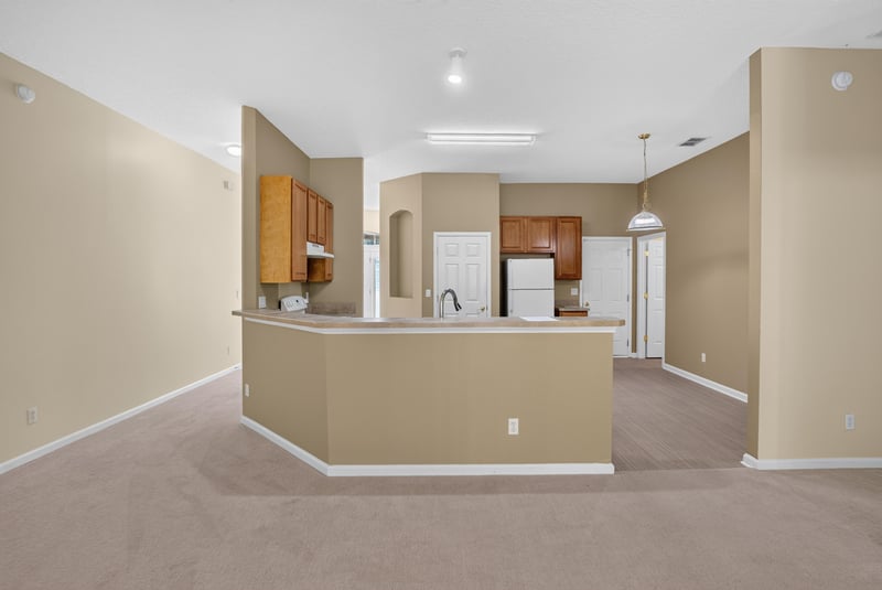 Kitchen island with white range and cabinets at 299 John's Creek Pkwy, St. Augustine, FL 32092