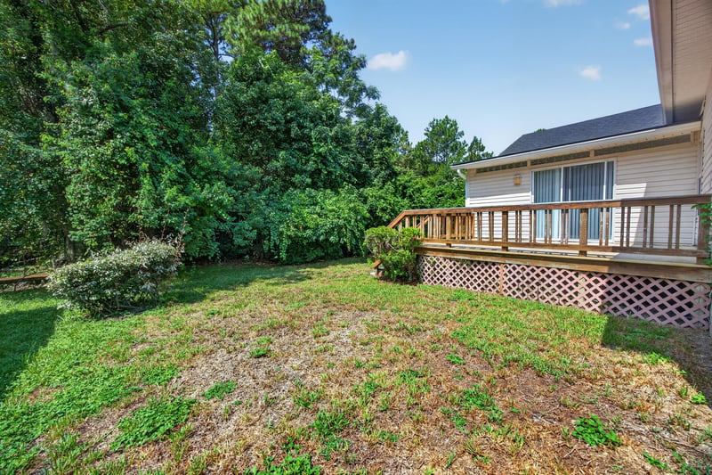 Backyard with deck and trees at 9256 Dale View Ln W, Jacksonville, FL 32225