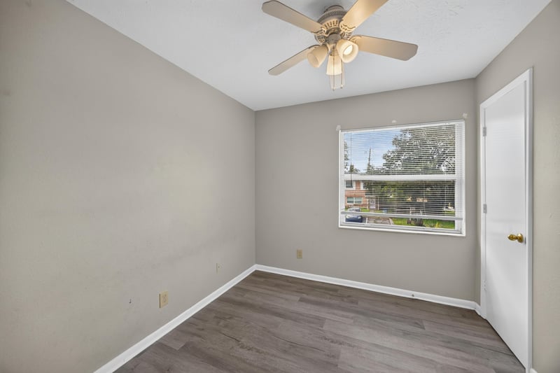 Bedroom with wood-look flooring and window at 2658 Trollie Ln apt 1, Jacksonville, FL 32211