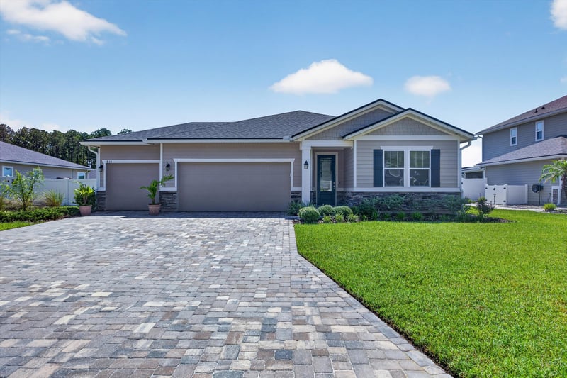 Front exterior with driveway and lawn at 855 Flach Dr, St. Johns, FL
