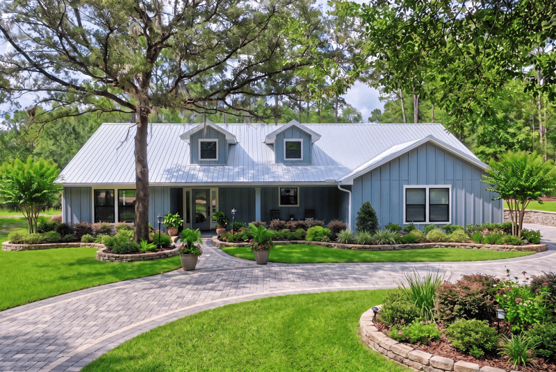 Front exterior with dormer windows and covered porch at 4800 Acacia St, Middleburg, FL 32068