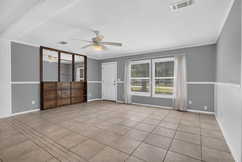 Empty living room with ceiling fan and tile flooring at 2549 Snapdragon Ave, Middleburg, FL 32068