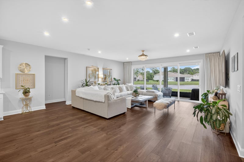 Living room with sectional sofa and wood floors at 85491 Fall River Pkwy, Fernandina Beach, FL 32034