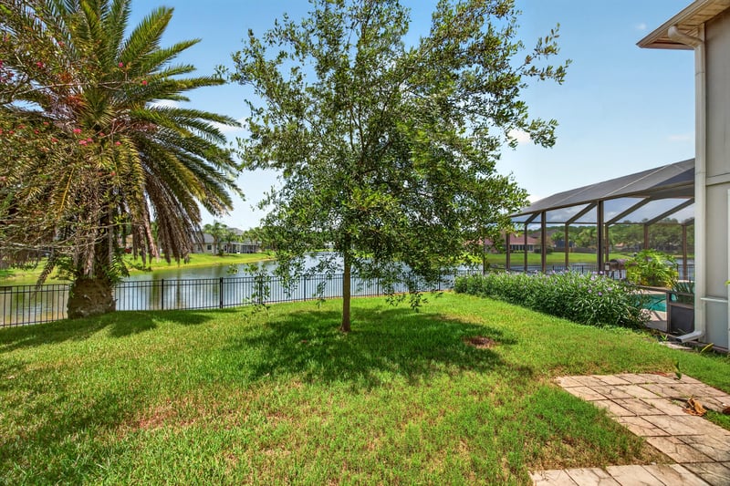 Backyard with lake view and trees at 1493 Greyfield Dr, St. Augustine, FL 32092