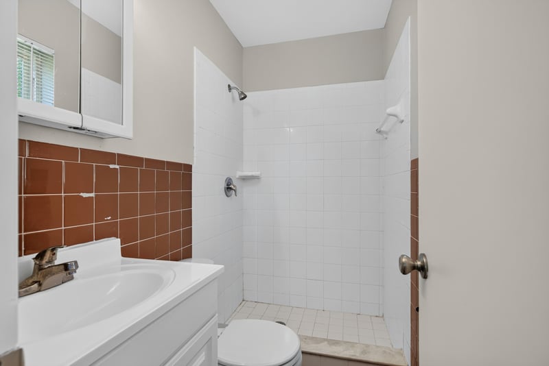 Bathroom vanity and tile shower at 5503 Boeing Dr, Jacksonville, FL 32207