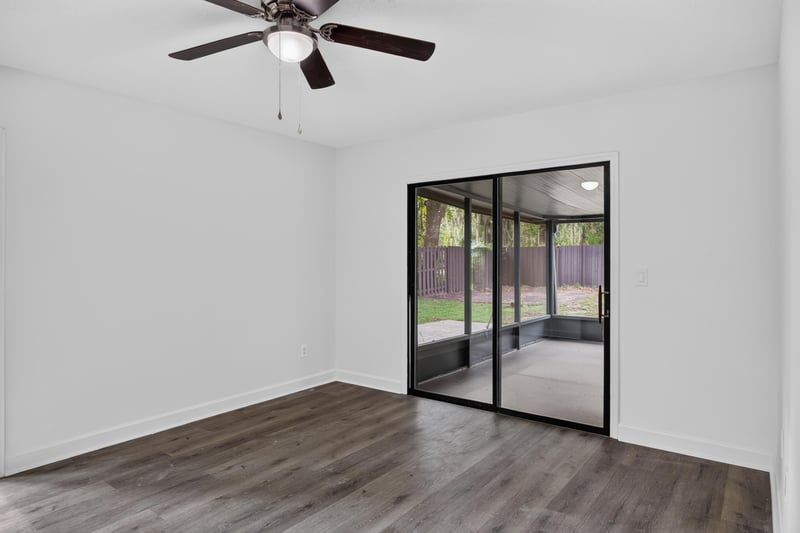 Room with sliding glass door and wood floor at 551 Deltona Blvd, St. Augustine, FL 32086