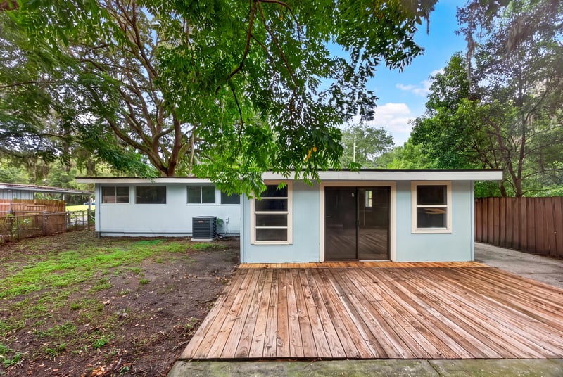 Rear exterior with wood deck and yard at 3113 Kline Rd, Jacksonville, FL 32246