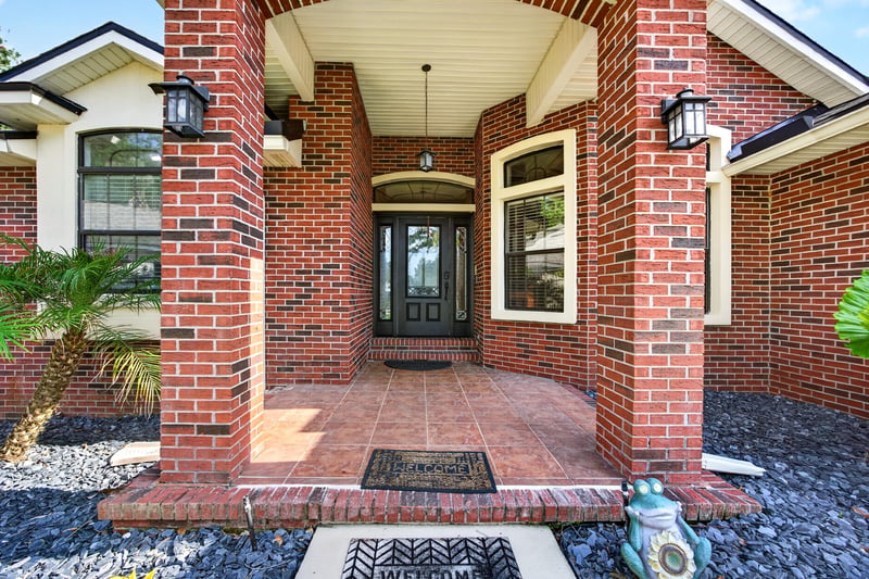 Covered front entry with brick columns at 2125 Blue Heron Cove Dr, Orange Park, FL 32003