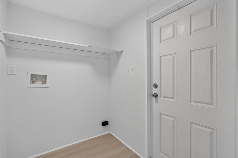 Laundry closet with shelf and hookups at 55520 Jewel-Thomas Rd, Callahan, FL 32011