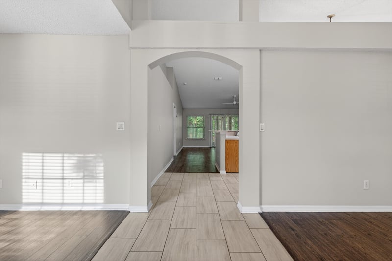 Hallway with wood flooring and arched doorway at 1648 Glen Laurel Dr, Middleburg, FL 32068
