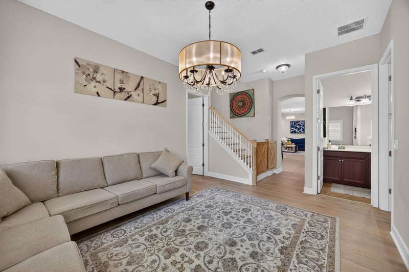 Living room with staircase in background at 276 Cross Ridge Dr, Ponte Vedra Beach, FL 32081