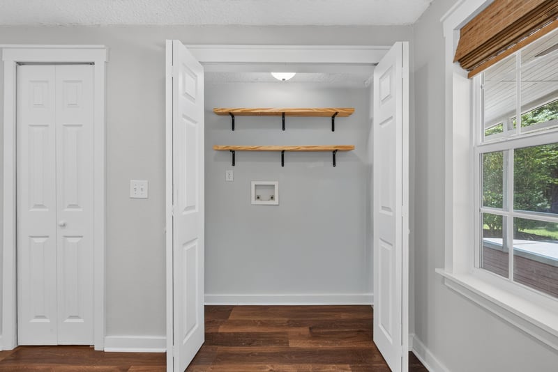 Mudroom nook with open shelving and wood floor at 4890 McAllister Rd, Middleburg, FL 32068