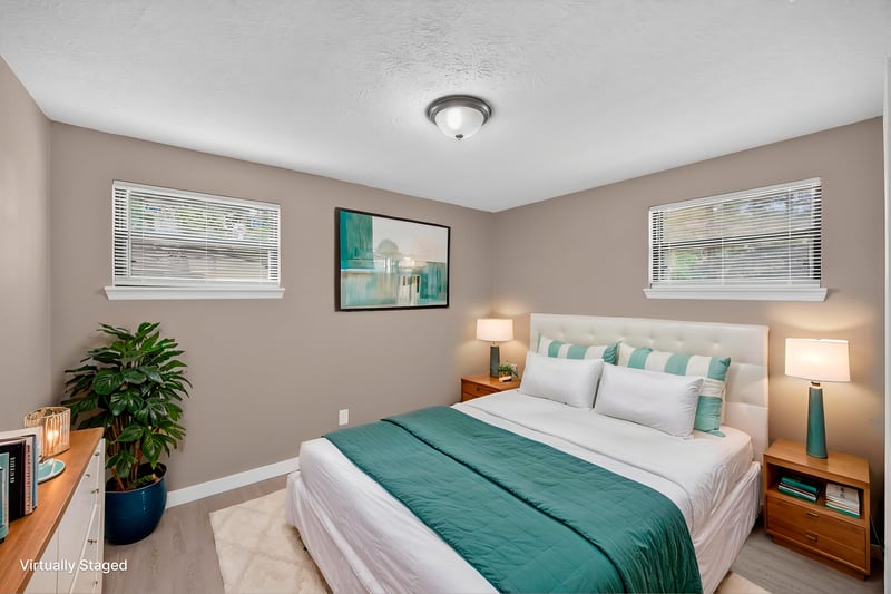 Virtually staged bedroom with green bedding at 184 Draco St, Orange Park, FL 32073