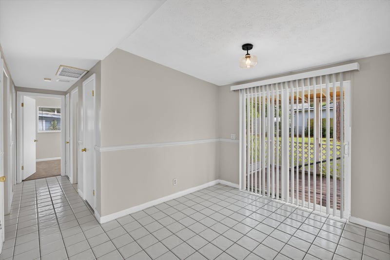 Dining area with tile floor and sliding doors at 87 Saratoga Cir S, Atlantic Beach, FL