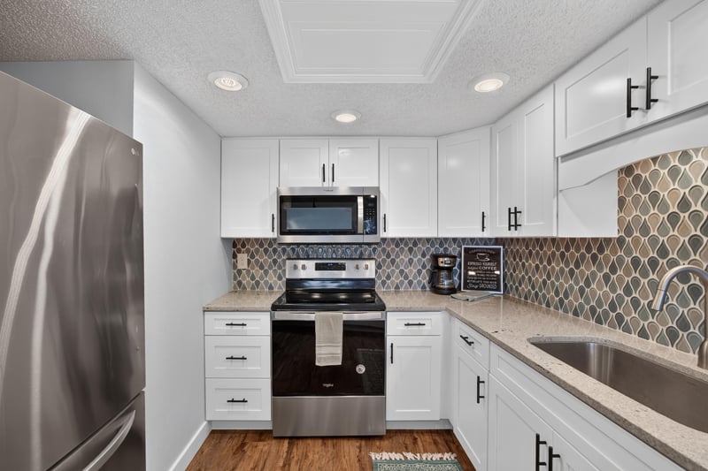Kitchen with patterned tile backsplash at 2280 Shepard St