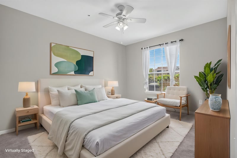 Primary bedroom with staged furnishings and window at 7990 Baymeadows Rd E #404, Jacksonville, FL 32256