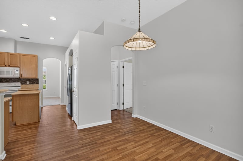 Kitchen open to living area with pendant lighting at 2480 Ridge Will Dr, Jacksonville, FL 32246