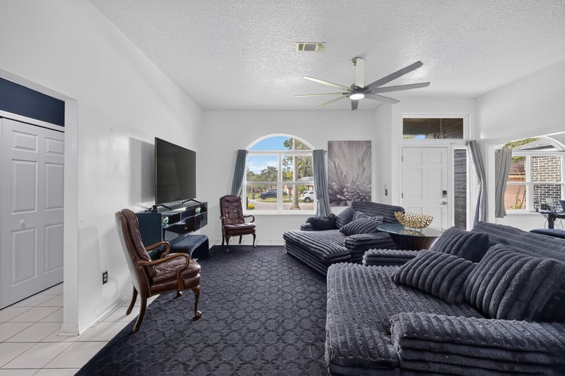 Wide view of the living room and arched windows at 1346 Gately Ct, Jacksonville, FL 32225