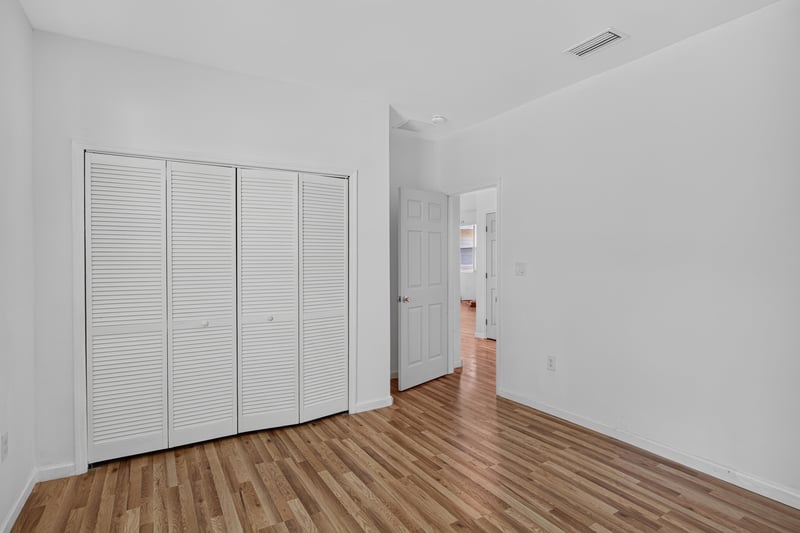 Bedroom with closet doors and hallway view at 1012 Fruit Cove Rd, Jacksonville, FL 32259