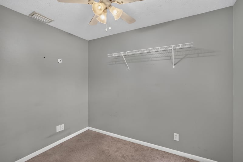 Carpeted room with closet shelving at 6757 Deer Springs Rd, Keystone Heights, FL 32656
