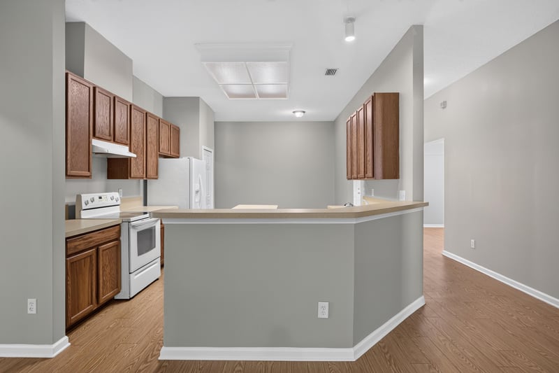 Kitchen with wood cabinets and white stove at 14147 Fish Eagle Dr E, Jacksonville, FL 32226