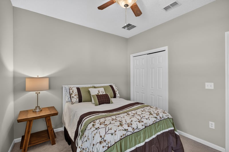 Bedroom with matching nightstands and ceiling fan at 3660 Middlebrook Dr, Orange Park, FL 32065