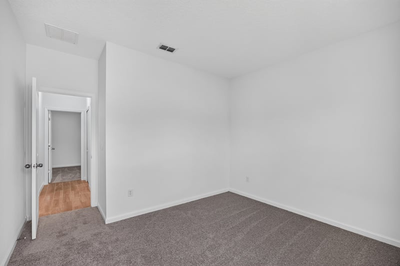 Bedroom doorway with wood-look flooring beyond at 9905 Ansley Lake Dr, Jacksonville, FL