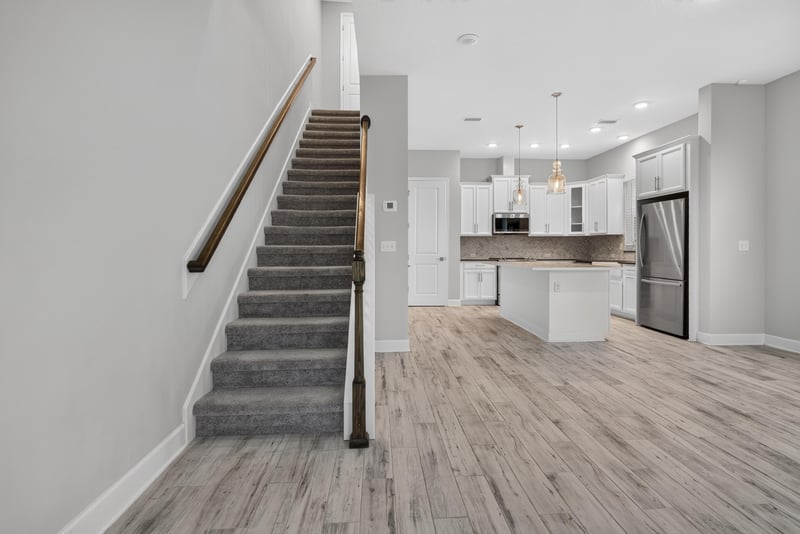 Entry hallway with staircase and wood-look floors at 7446 Loggerhead Ct, Jacksonville, FL 32256