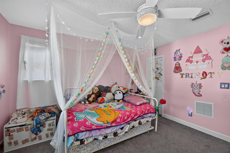 Bedroom with canopy bed and window seating at 2817 Camel Cir, Middleburg, FL