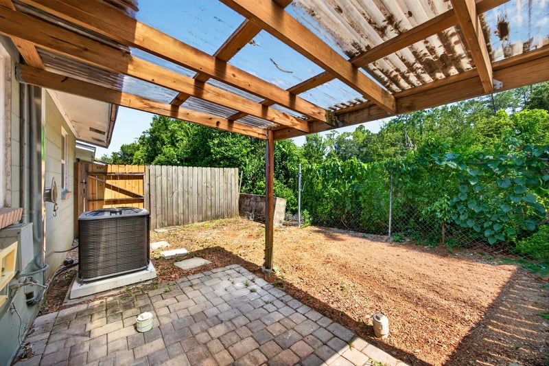 Covered patio with wood pergola and AC unit at 8067 Parental Cir, Jacksonville, FL 32216