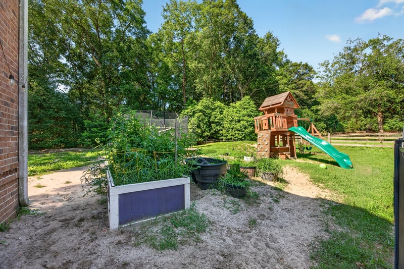 Backyard garden area with swing set at 1735 Hagans Ridge Ct