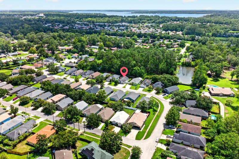 Drone aerial of neighborhood and lake in the distance in Middleburg, FL