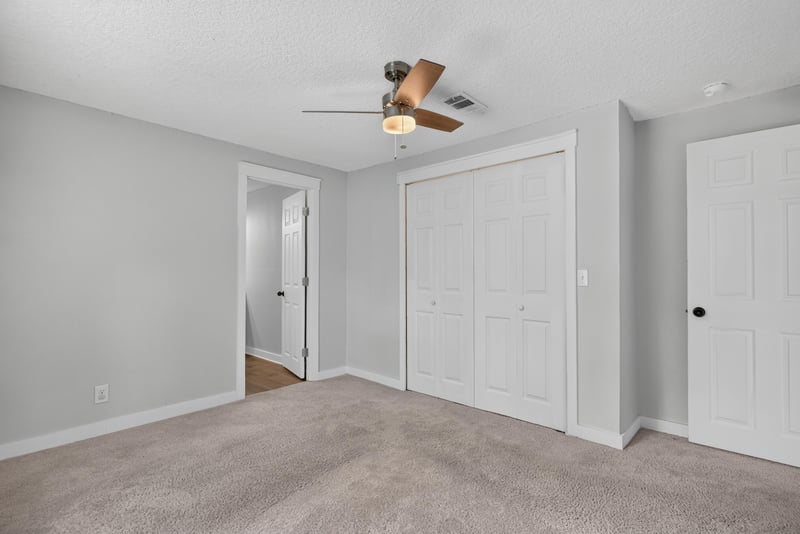 Bedroom with carpet and double closets at 4890 McAllister Rd, Middleburg, FL 32068