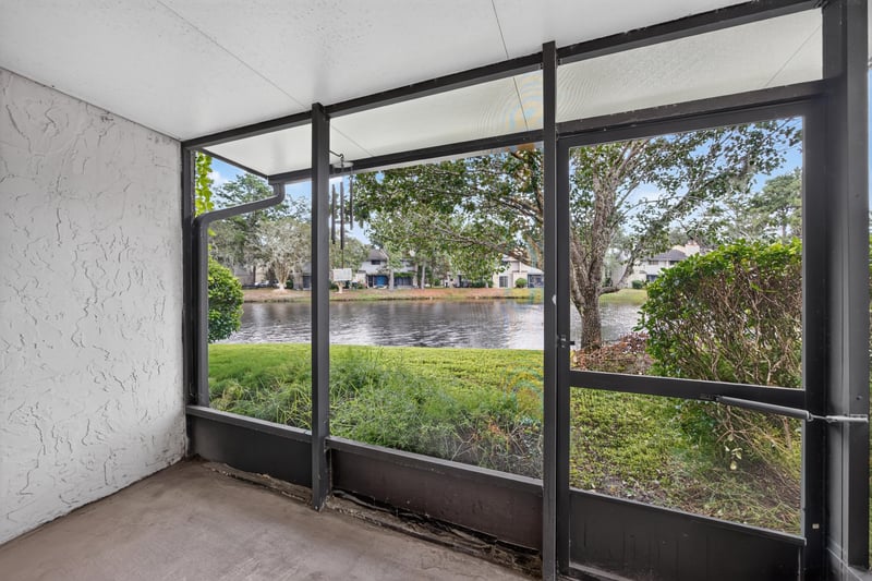 Screened porch overlooking pond and trees at 3801 Crown Point Rd, Jacksonville, FL 32257