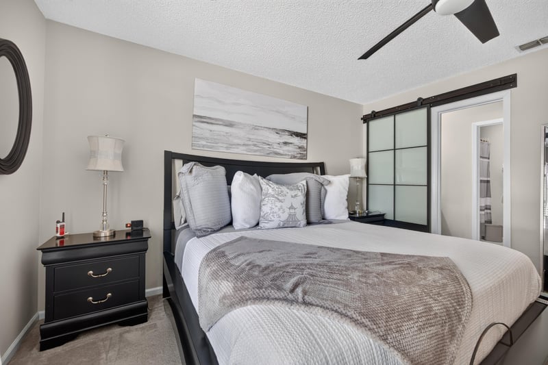 Primary bedroom with dark wood furniture at 3067 Wavering Ln, Middleburg, FL 32068