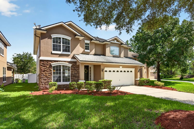 Front exterior close-up showing stucco facade and stone accents at 3660 Middlebrook Dr, Orange Park, FL 32065