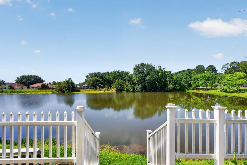 Pond view with white picket fence at 8680 Bandera Cir S, Jacksonville, FL 32244