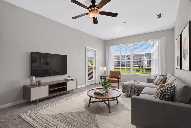 Living room with ceiling fan and windows at 7990 Baymeadows Rd E #404, Jacksonville, FL 32256