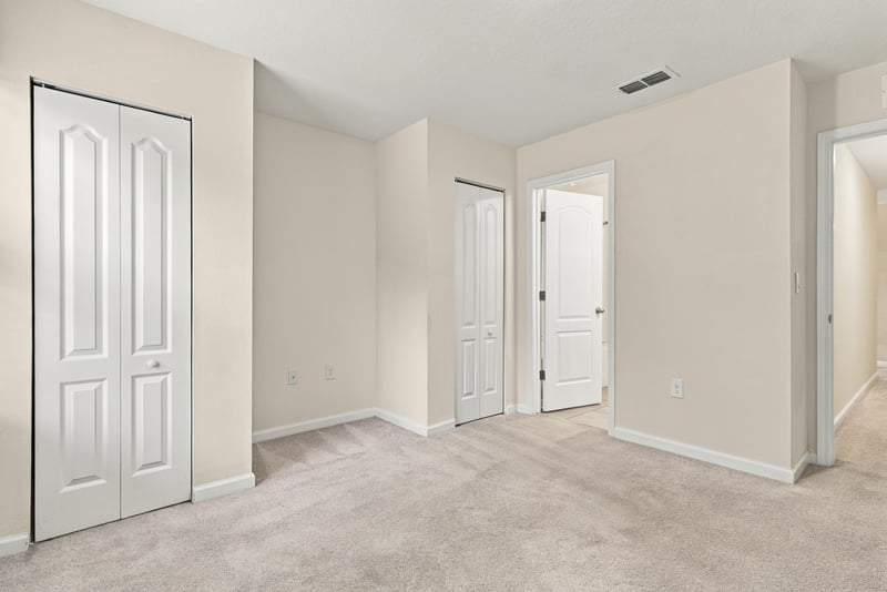 Empty bedroom with closet doors at 9555 Star Dr, Jacksonville, FL 32256