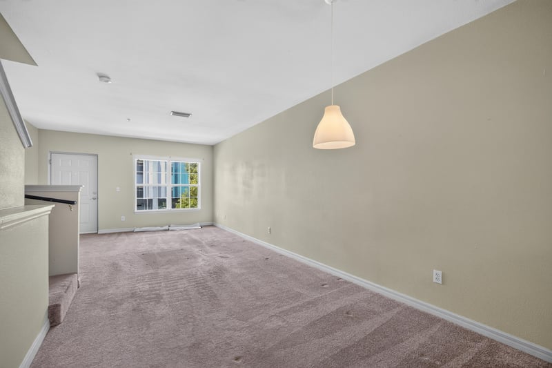 Living room corner with carpet and pendant light at 342 E Ashley St, Jacksonville, FL 32202