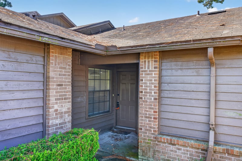 Front entry door and brick facade at 8010 International Village Dr, Jacksonville, FL 32277