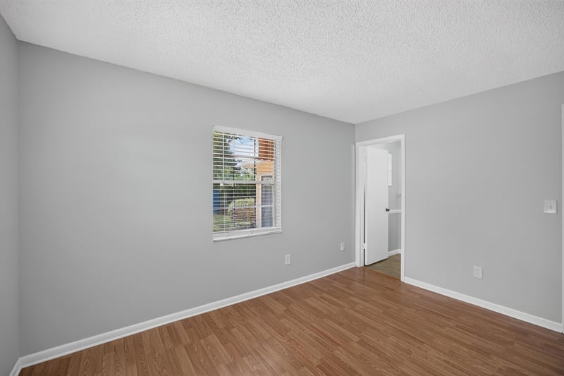 Bedroom with window and wood laminate flooring at 328 Palos Ct, St. Augustine, FL