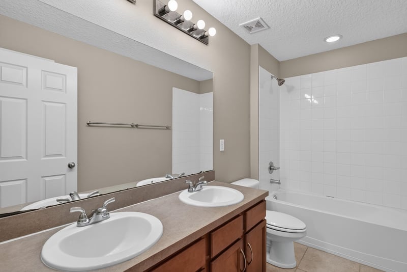 Bathroom with double sink vanity and tub/shower combo at 13685 Goodson Pl, Jacksonville, FL 32226
