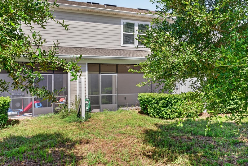 Side exterior with screened porch at 1186 Beach Dune Dr, Jacksonville, FL 32233
