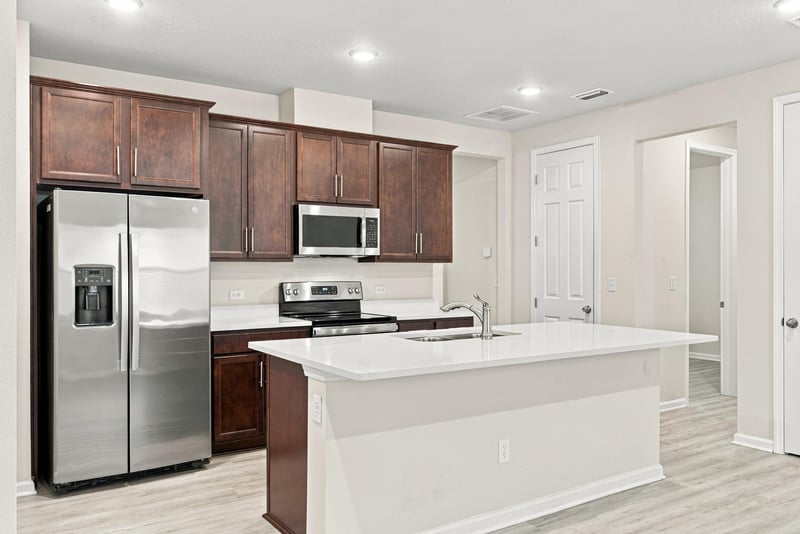 Kitchen island with quartz counters at 7088 Mahogany Run Dr, Jacksonville, FL 32244