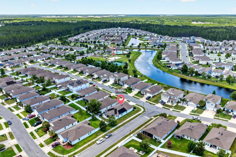 Aerial view of the neighborhood with pond and curving streets in Jacksonville, FL