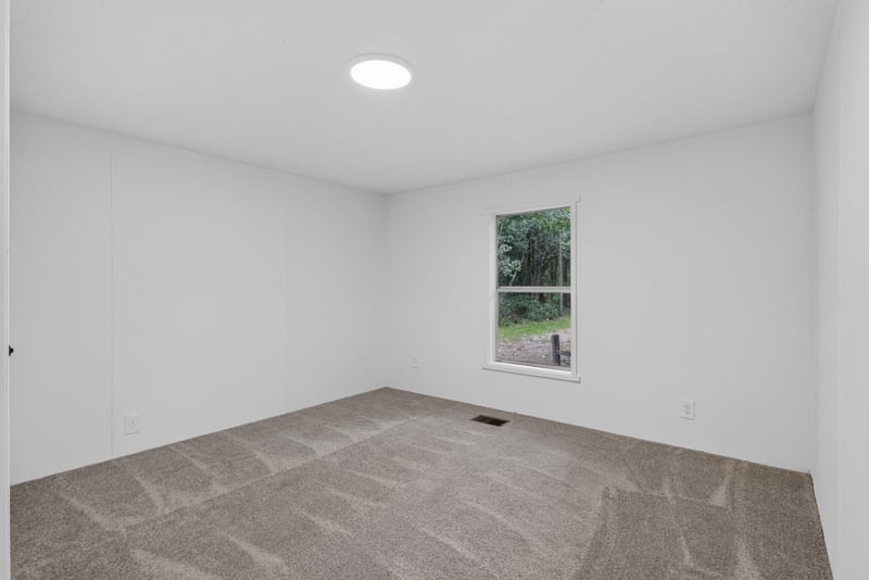 Bedroom with carpet and window at 55520 Jewel-Thomas Rd, Callahan, FL 32011
