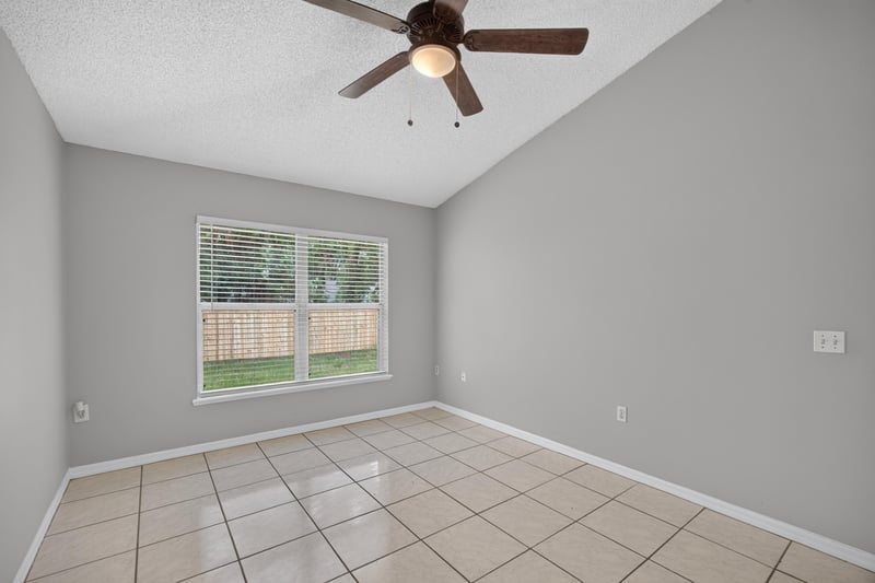 Bedroom with tile floor and ceiling fan at 7329 Lawn Tennis Ln, Jacksonville, FL