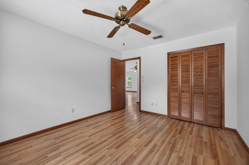 Empty room with wood floor and closet doors at 2460 San Sago Ln, Jacksonville, FL